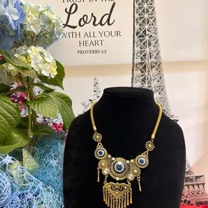 Gold necklace with blue beads and tassels